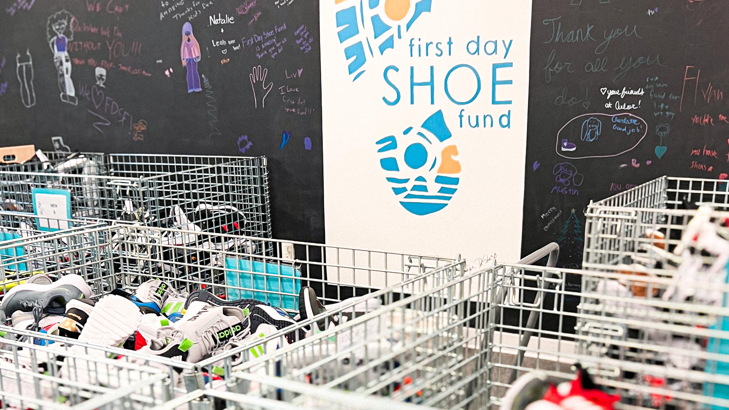 First Day Shoe Logo behind baskets of children's shoes