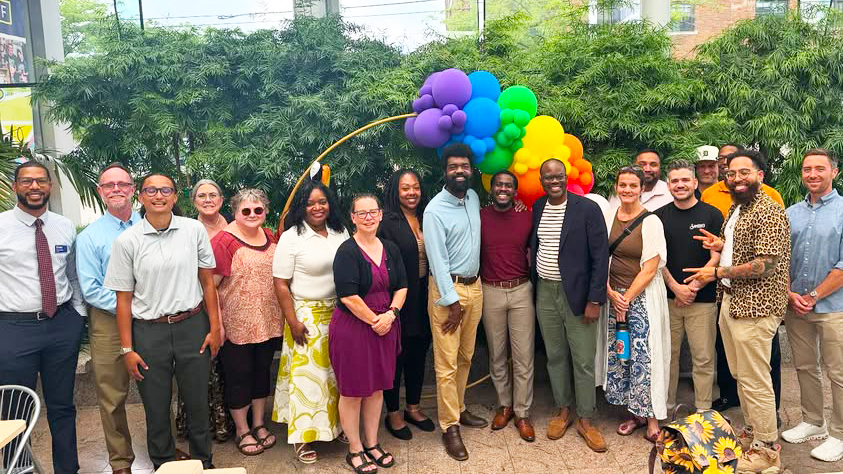 Image of KZEN members in front of greenery and brightly colored baloons