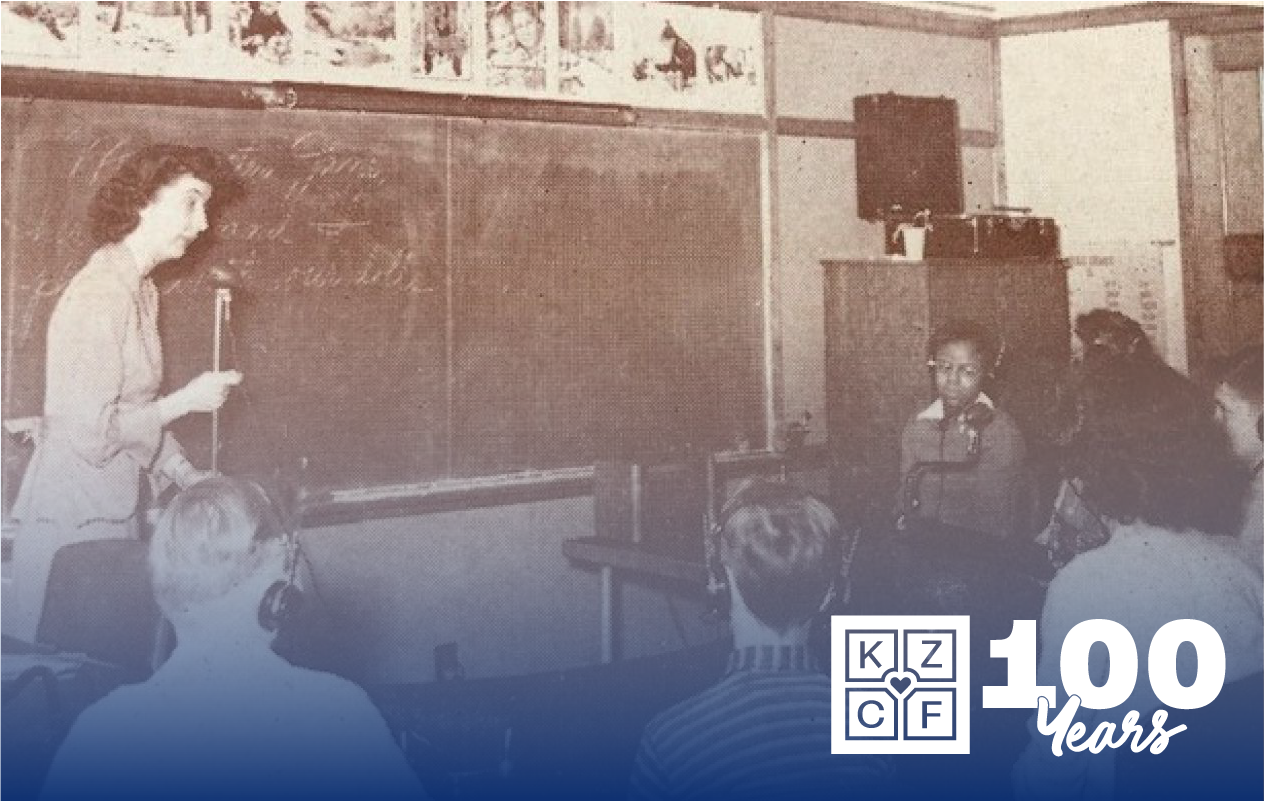 KZCF-History_Horizontal Kalamazoo Public Schools photo from 1930's, showing a teacher in front of a blackboard talking to students.