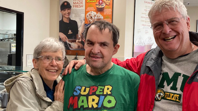 Photo of Jill Reid with her son Nick and her husband, Mark.