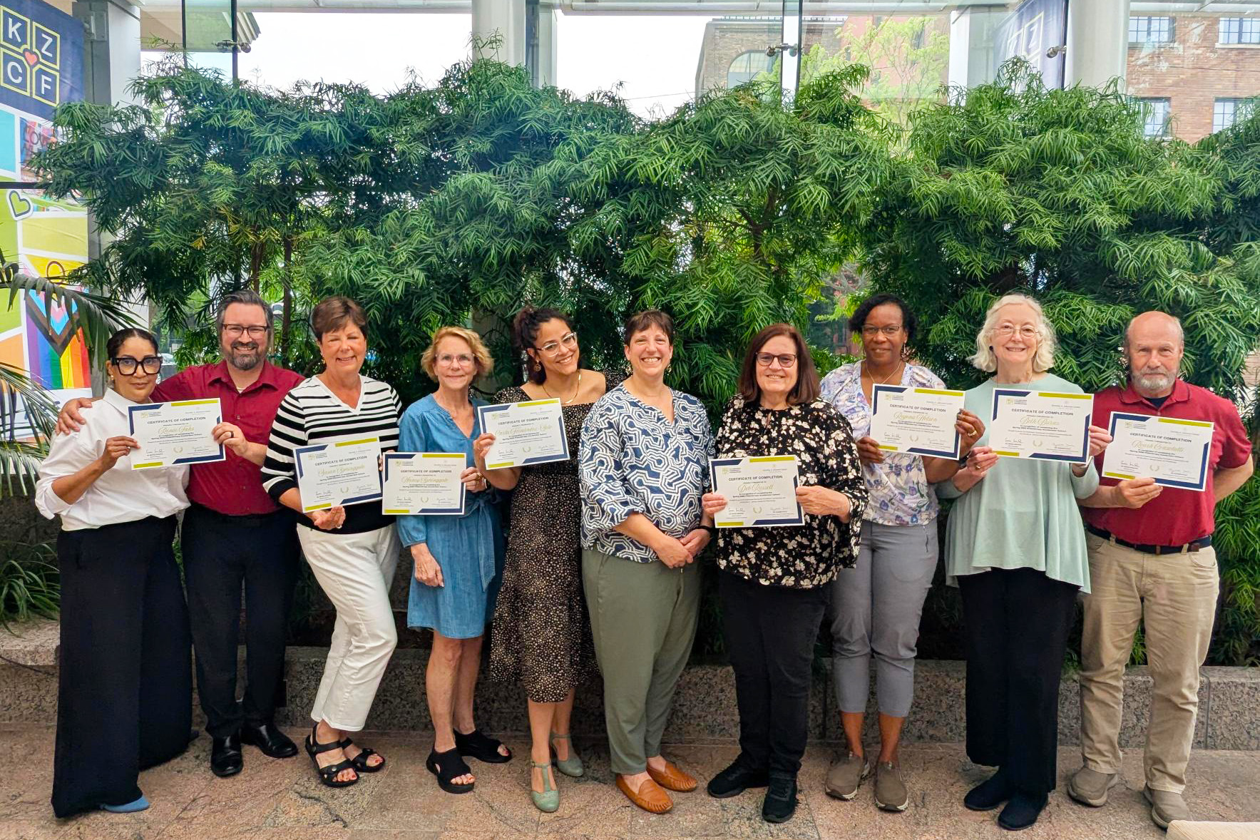 Graduates of our 2025 Philanthropy Cohort holding their certificates.