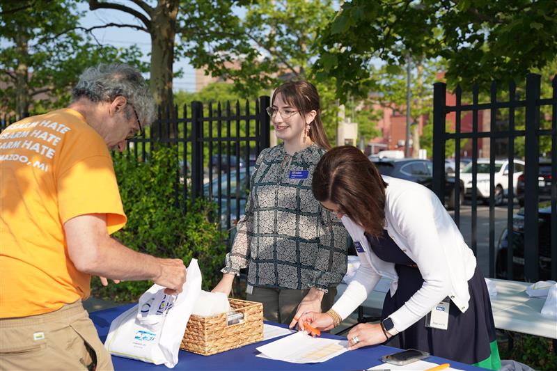 Image of KZCF staff registering an individual for our Love Where You Live Bus Tour